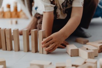 https://www.pexels.com/photo/child-placing-toy-blocks-7269696/